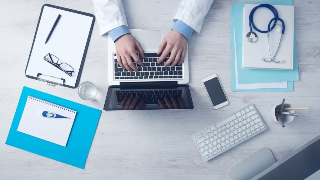 Olympia Compounding Pharmacy Providers Typing on Laptop