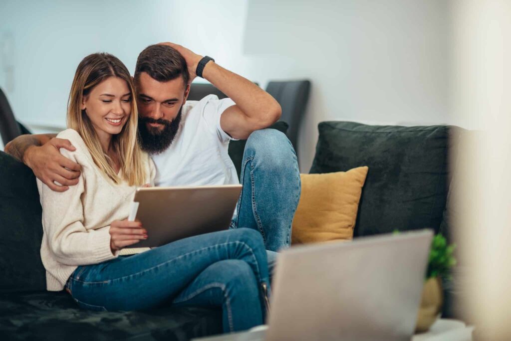 Man and woman using tablet.