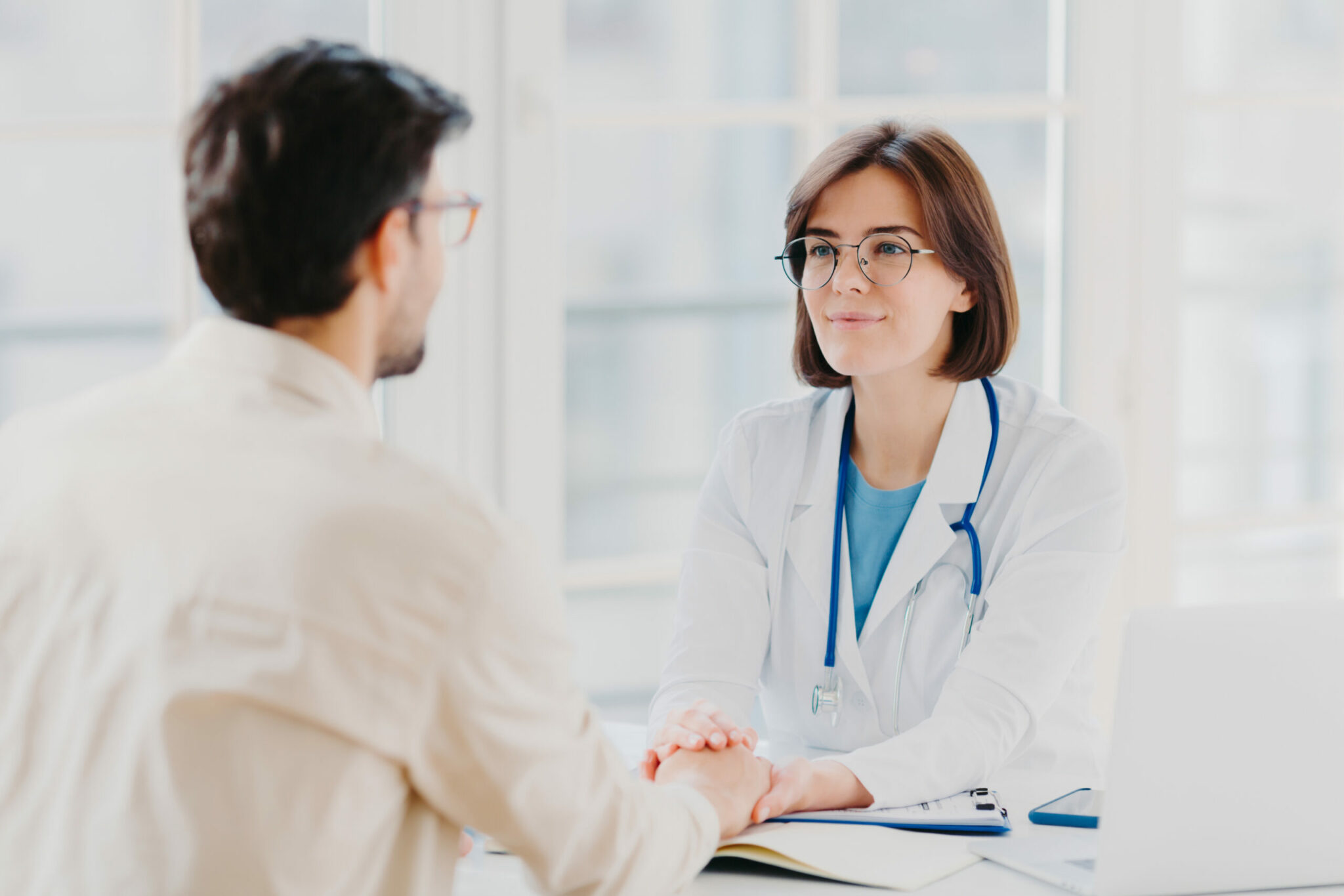 Man talking about ED with a female doctor that is supportive