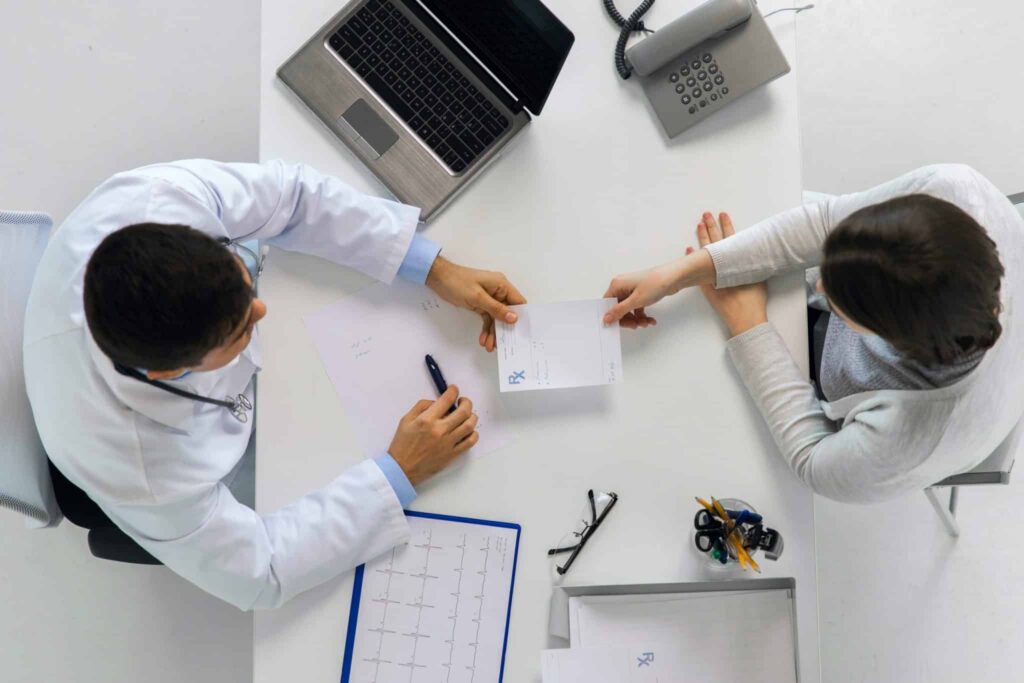 Pharmacist Receiving Prescription from Patient